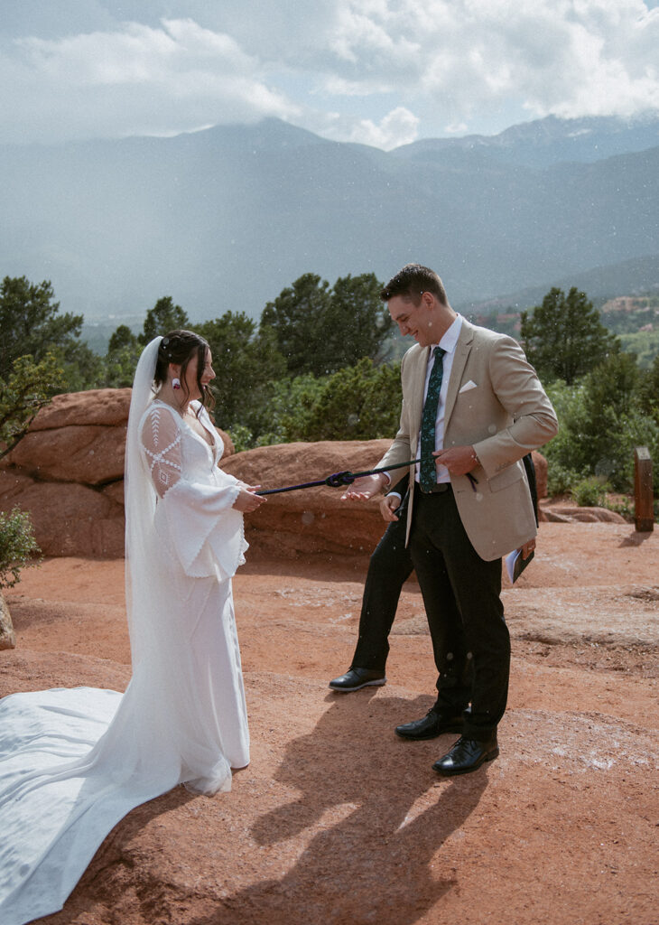 hand-fasting ceremony at a garden of the gods elopement
