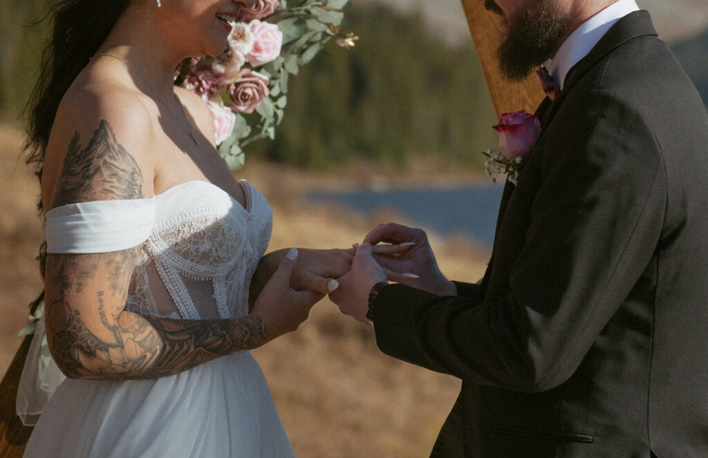 A couple exchanges rings during their ceremony