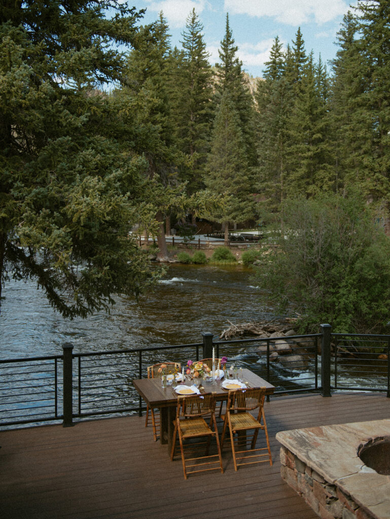 An intimate Colorado elopement day table set for dinner along the river