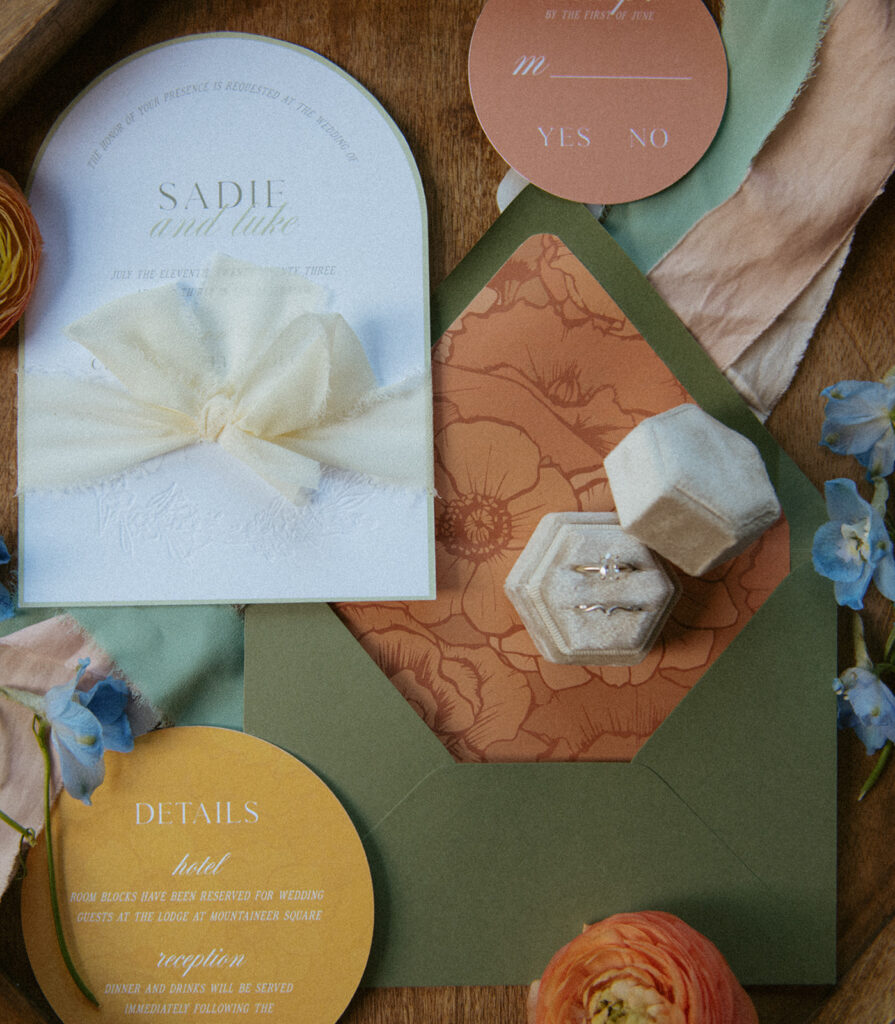 Colorado elopement invitation suite with wedding rings and florals