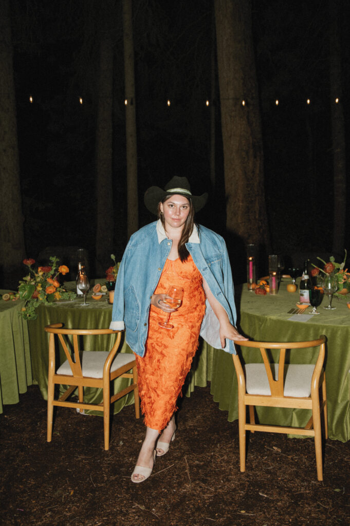 A Colorado wedding photographer stands in front of a micro wedding reception table