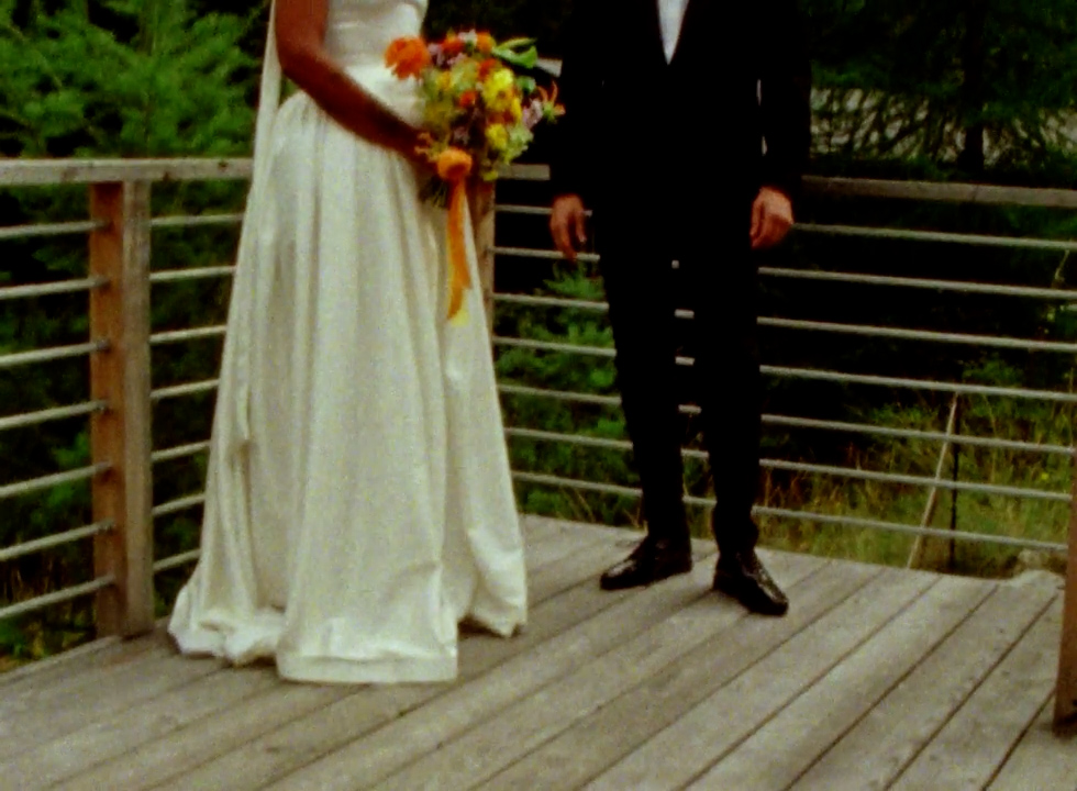 a couple stands in their wedding attire