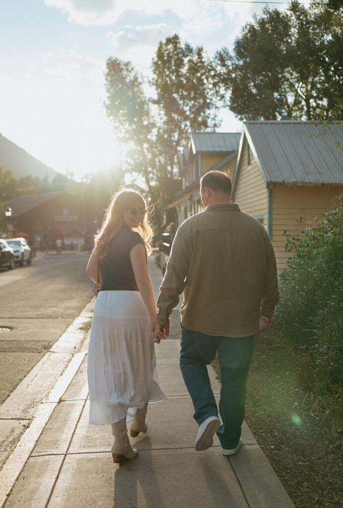 a couple walks in telluride hand in hand the night before their wedding